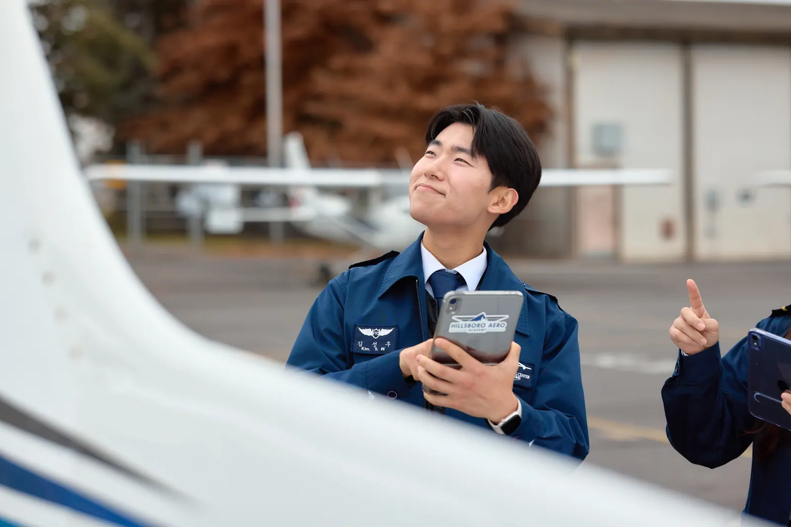 A student pilot looking up at the aircraft before a flight